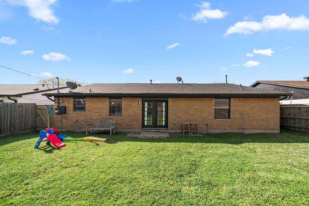 Notice the brick on the back side of the property along with the double French doors.