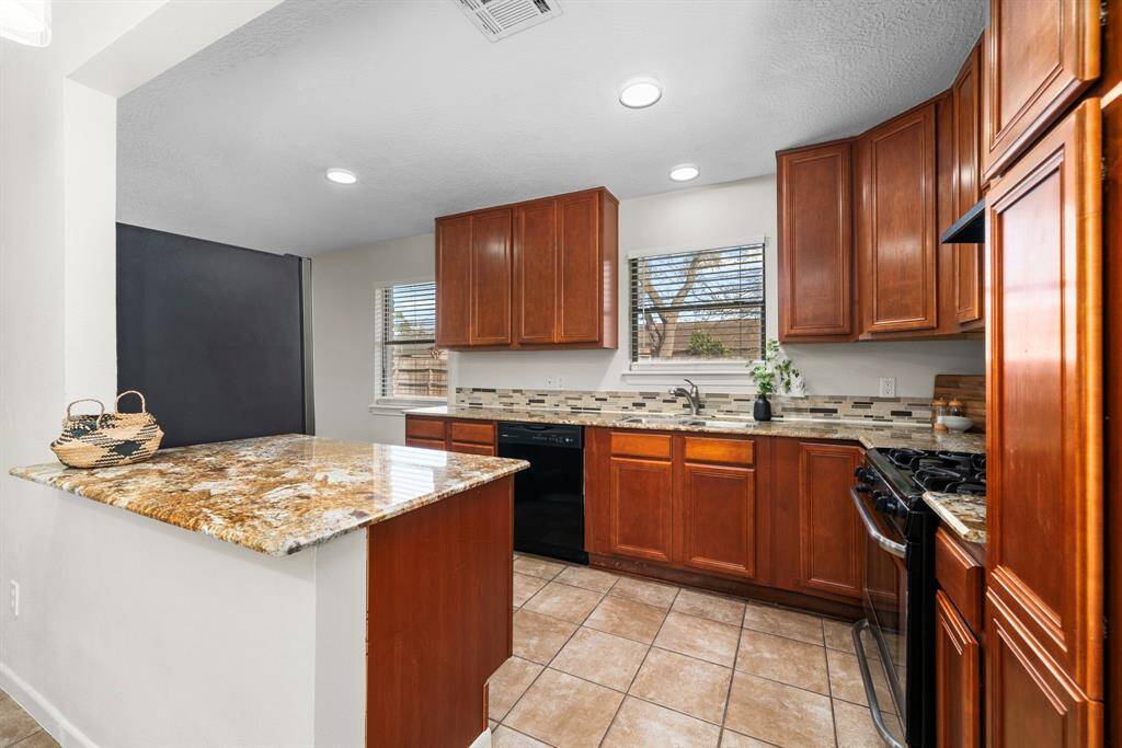 Gas range and kitchen sink overlooking backyard!