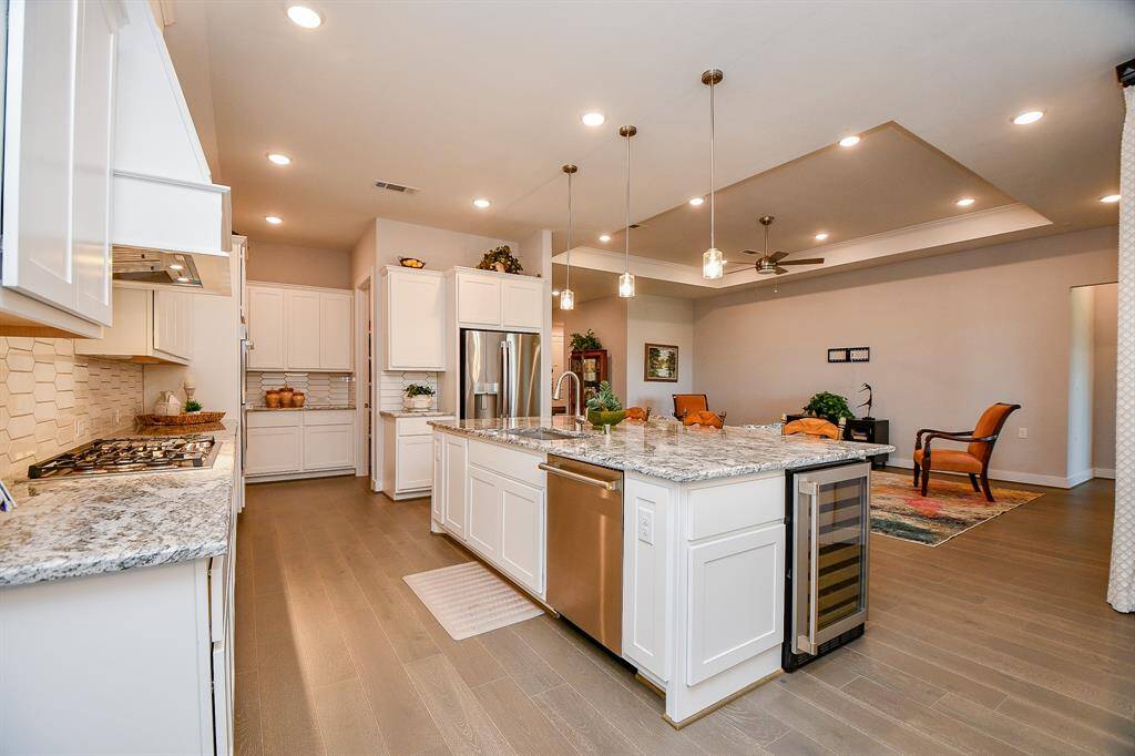 The den flows into the kitchen so the chef can enjoy the the rest of the family and company.