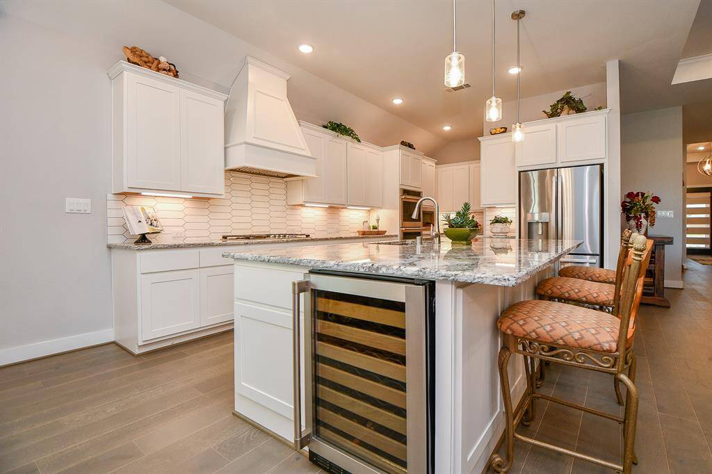 There is a wine cooler tucked under the island countertop.