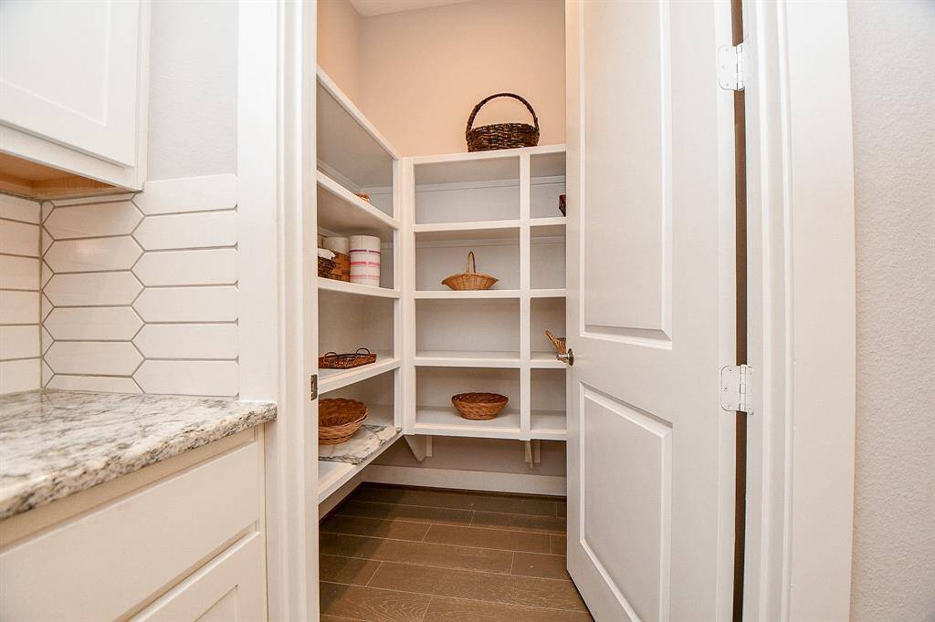 Spacious walk-in pantry with ample shelving and storage, perfect for keeping your kitchen organized. A chef’s dream, offering easy access to all your essentials!