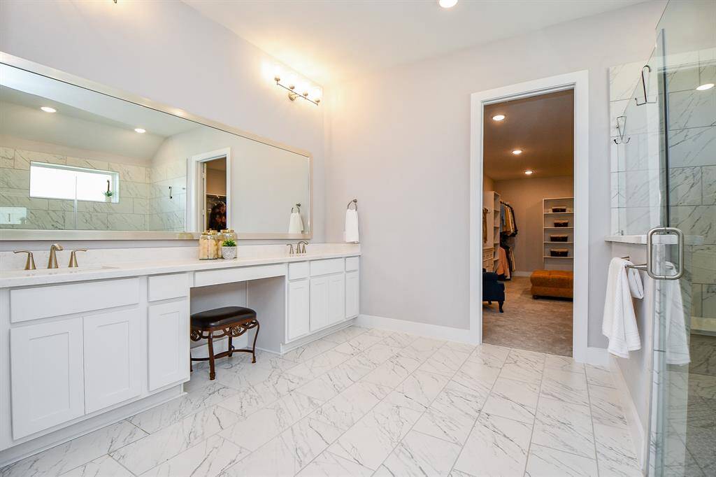 The Primary Bathroom has plenty of counter space, a vanity area and double sinks. Not pictured is the separate toilet area and linen closet.