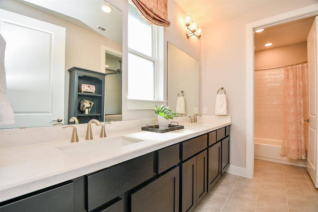 The secondary bathrooms is between the 2 bedrooms and has double sinks, huge counter top and a window.