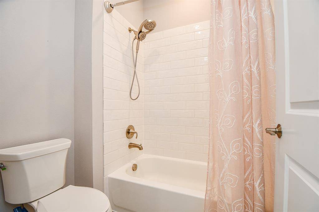 at the end of the bathroom is the separate tub and toilet area.