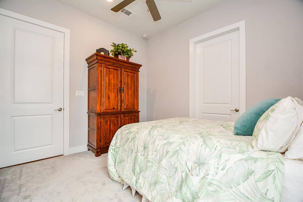 The other secondary bedroom has a walk-in closet and ceiling fan.
