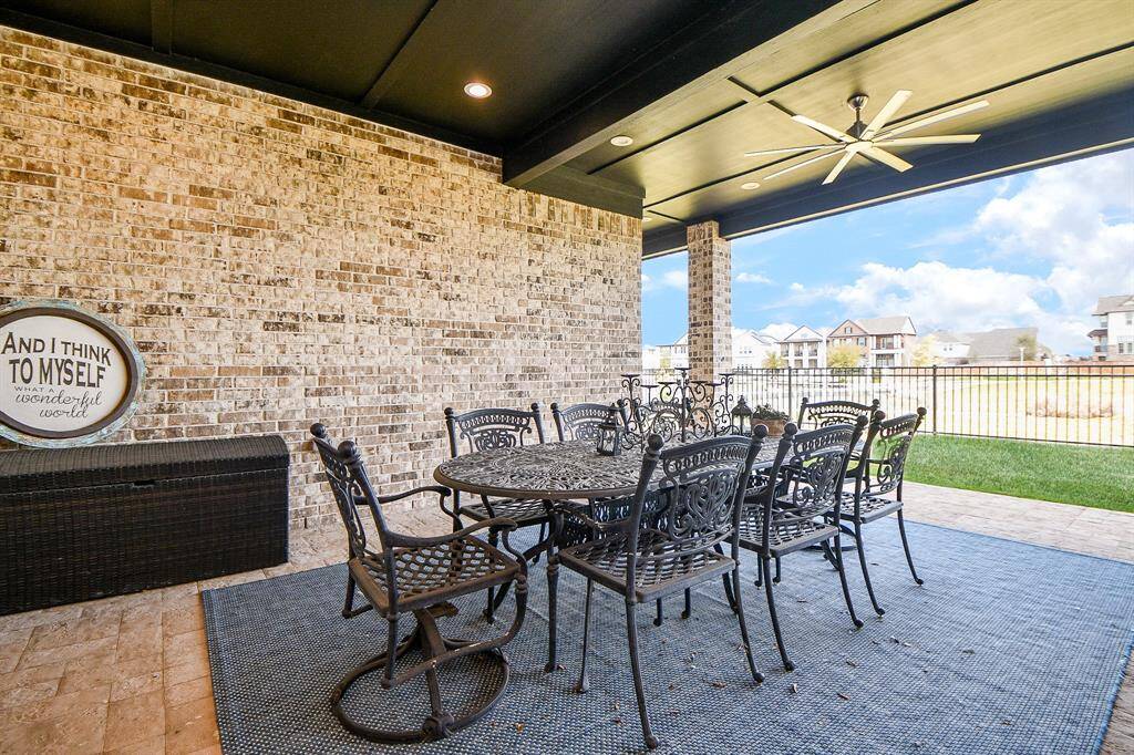 The patio has been extended to accommodate a very large table making outside entertaining a dream. The lake is just beyond the wrought iron fence.
