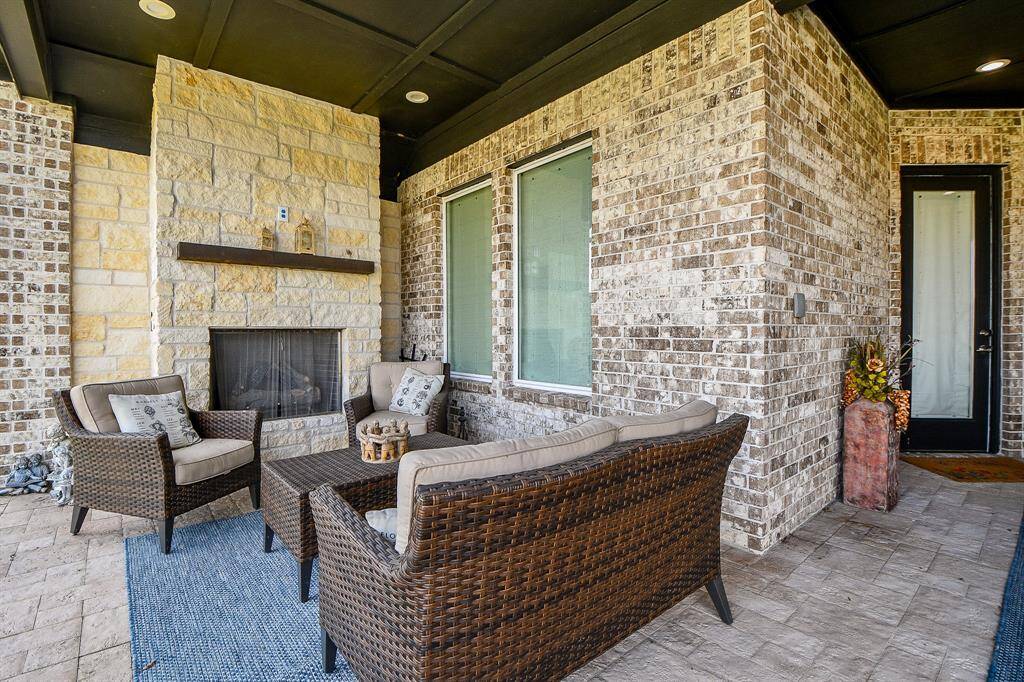 The gas log fireplace enhances this perfect outdoor gathering area, complete with views of the lake.
