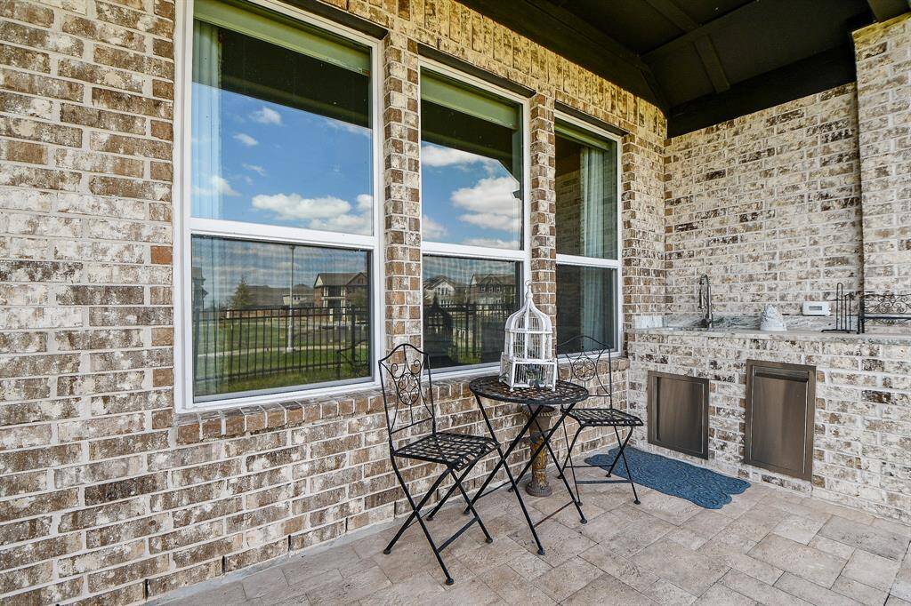 The patio area also includes a sink and granite counter working space.
