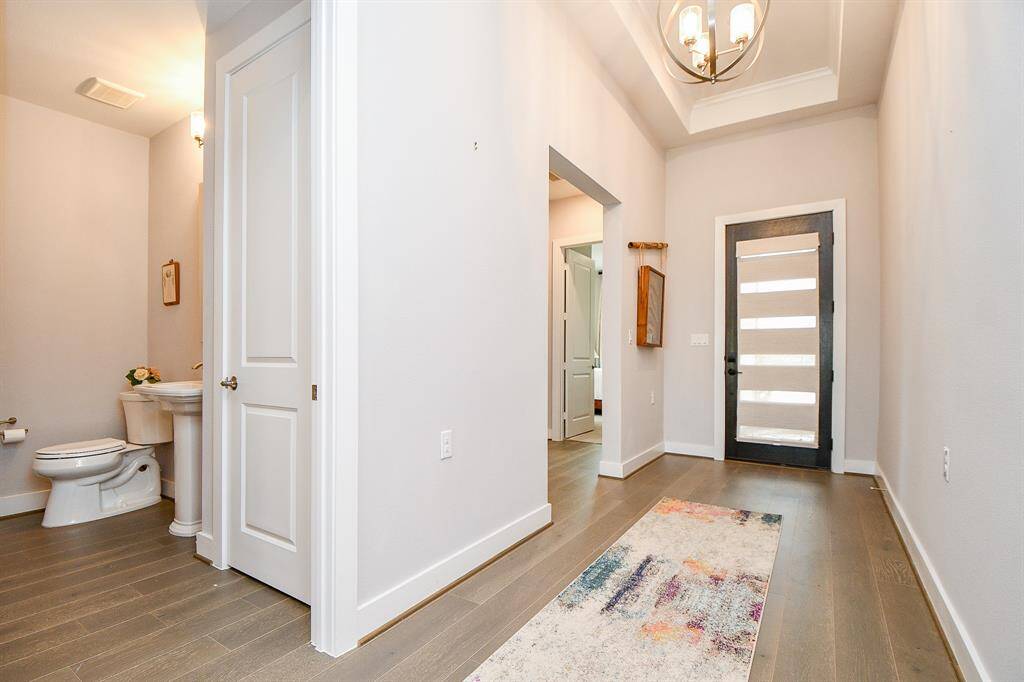 As you enter this lovely home, you will find the alcove to the secondary bedrooms followed by the powder-room conveniently separated from the common areas of the house.