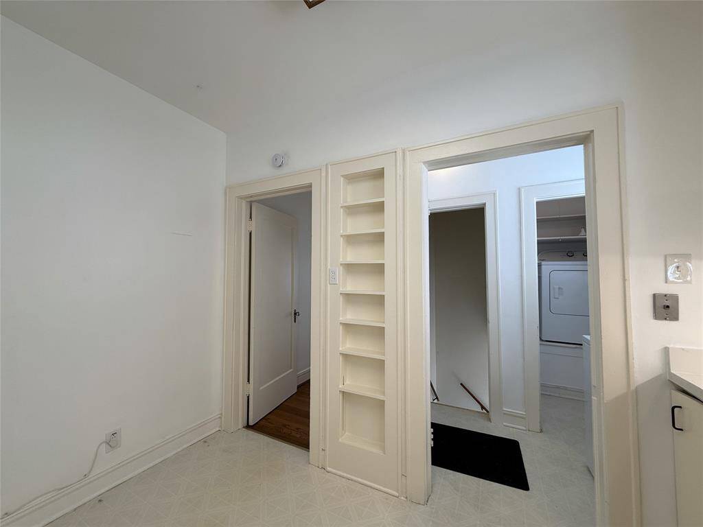 To the left of the built-in spice rack, a privacy door opens into hallway leading to the bedrooms & bathroom.