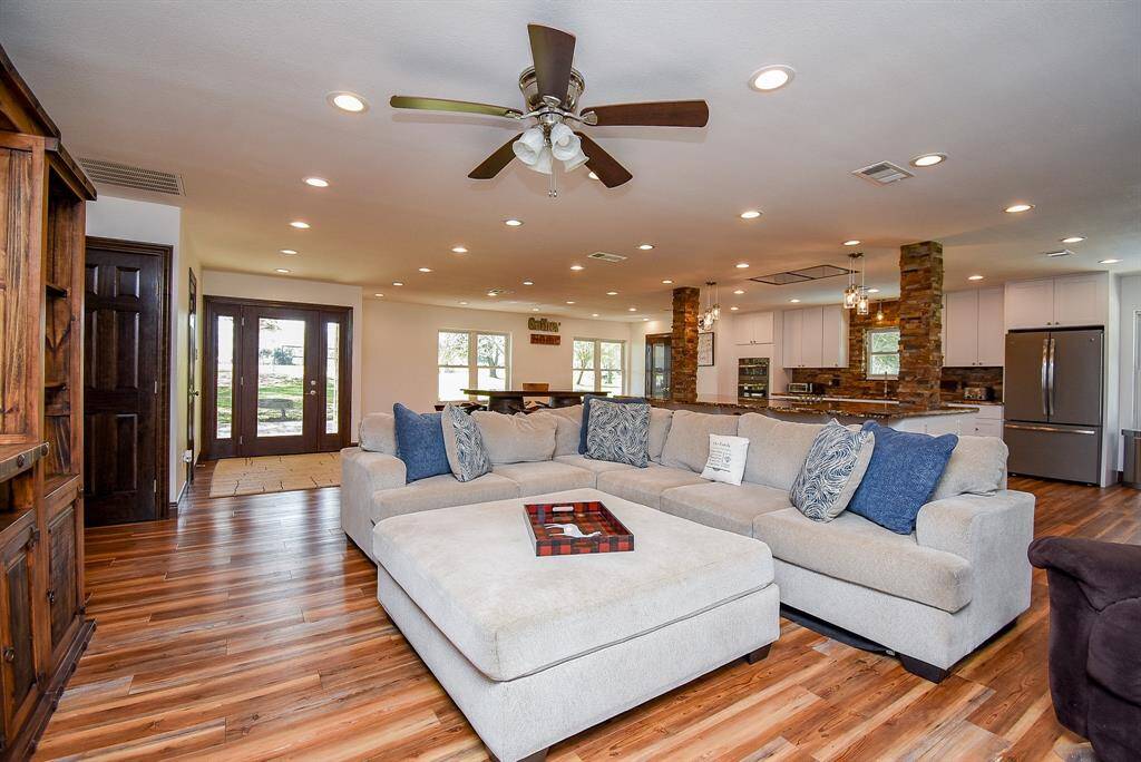 Notice the stunning flooring that runs throughout the living area, adding warmth and sophistication. The leaded glass front door further enhances the elegant nature of this home, making a beautiful first impression.