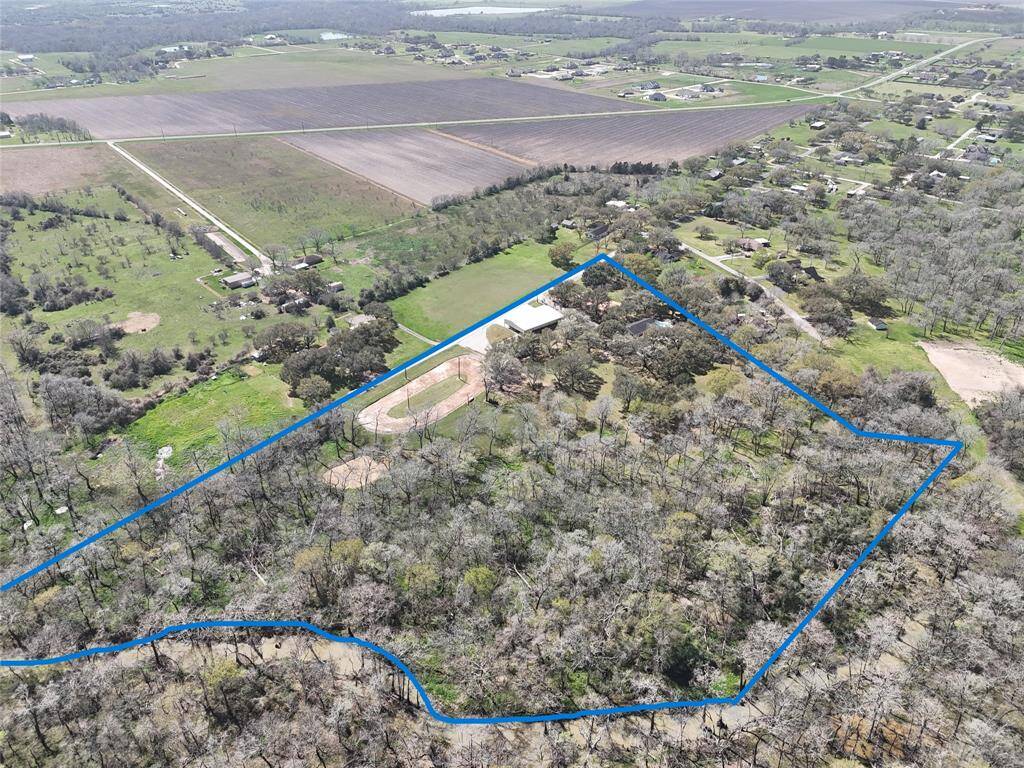 This view provides a clear perspective of the property lines. Spanning nearly 13 acres with riverfront access, this property offers endless potential.