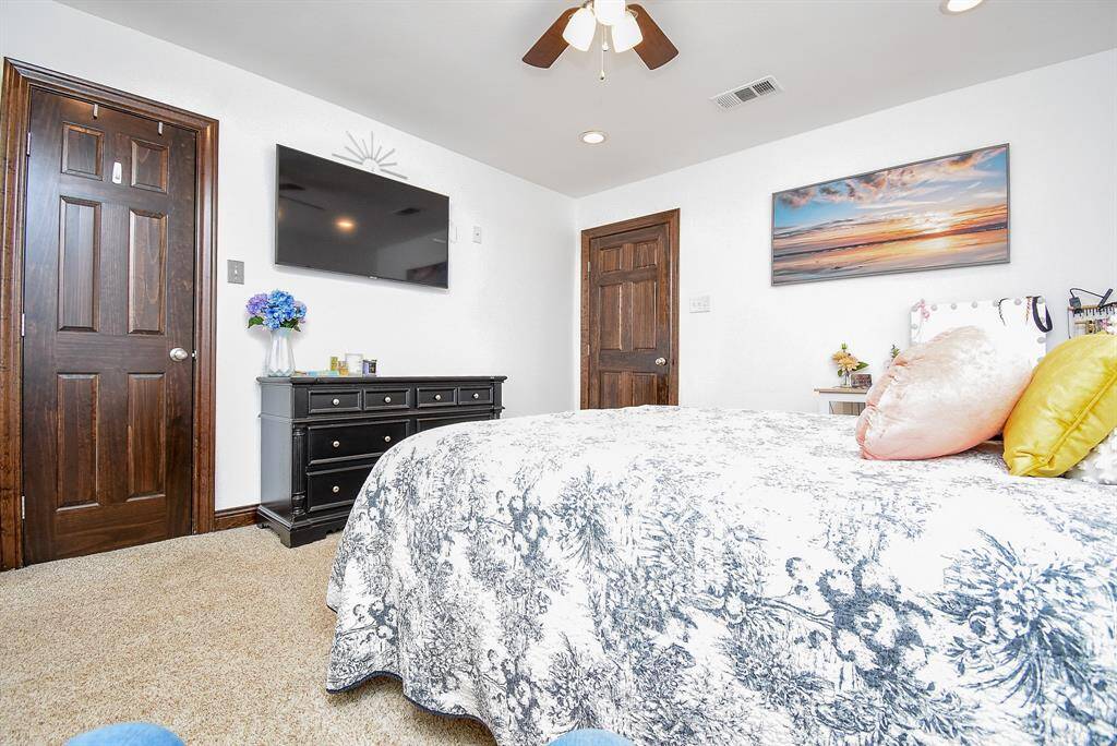 Here’s one of the guest bedrooms in the main house. You’ll notice the recessed lighting throughout every room, providing warmth and brightness whenever needed. This bedroom also features a spacious walk-in closet.