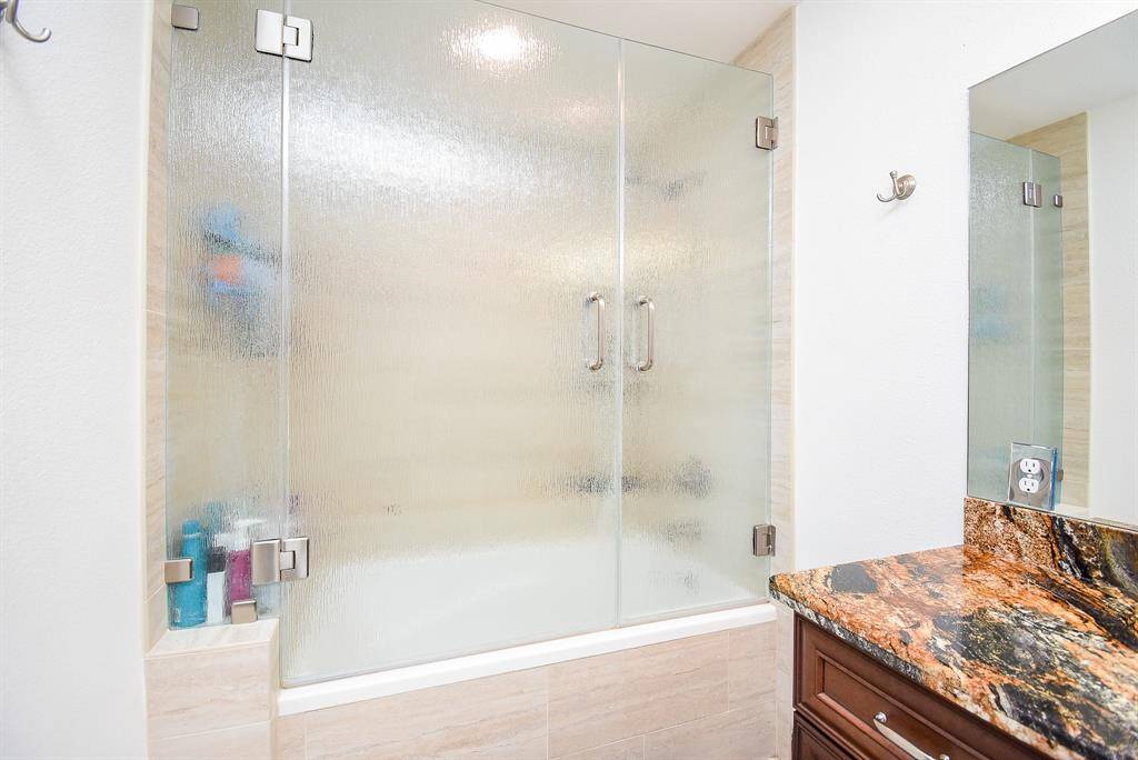 This shower/tub combo is simply beautiful. Notice the elevated ledge, offering extra comfort and added space.