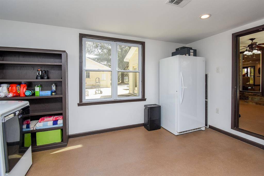 Here’s another view of this expansive utility room. There’s plenty of space for an extra refrigerator, deep freezer, or even the option to turn it into a craft room!