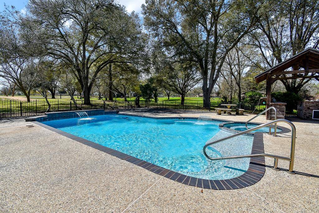 Imagine relaxing by the pool with this peaceful view. The two water features add to the tranquil ambiance, creating the perfect atmosphere for your country oasis.