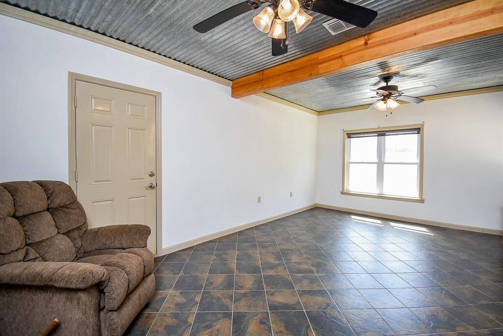 There’s plenty of room to comfortably add a bed and sofa in this studio apartment. The door leads directly to the garage.