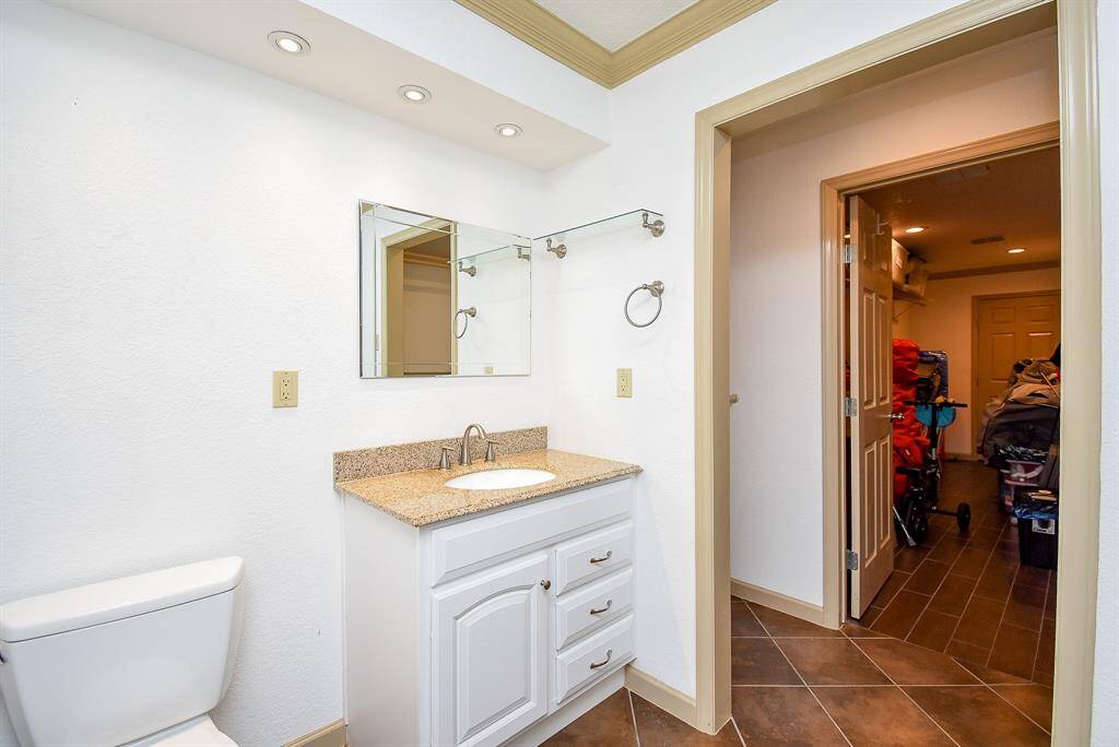 Step into the full bathroom inside this apartment. To the right, you'll find a generously sized closet, and beyond that is an extra-large hallway, perfect for additional storage or the potential start of a new room expansion.