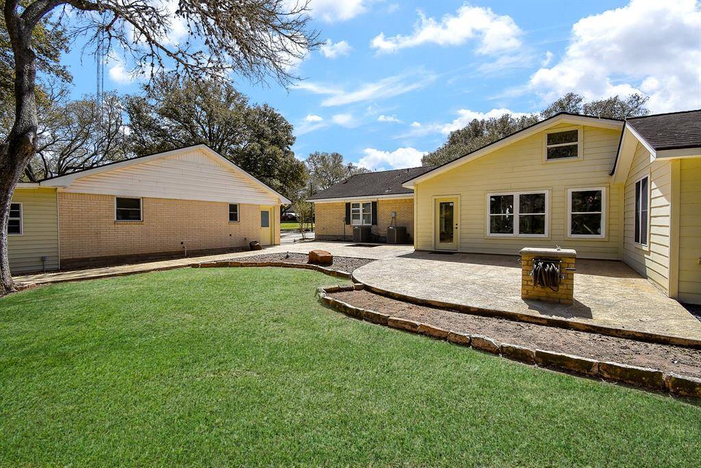 From this angle, you can see the backdoor leading into the sunroom of the main house, as well as the door to the garage apartment. Not visible here is an awning off the back of the apartment, which offers extra covered storage space or could easily be transformed into a charming covered porch.