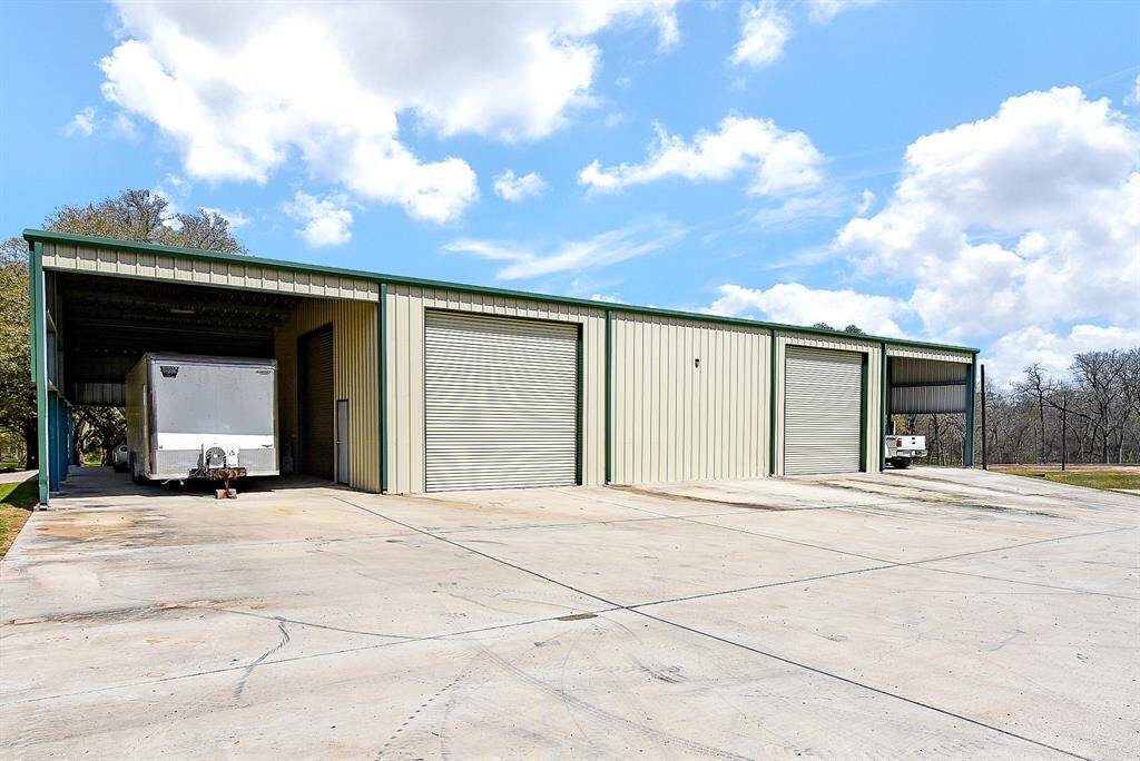 The front side of the shop highlights the extra concrete slab, offering additional parking and workspace. This space really needs to be seen in person to be fully appreciated!