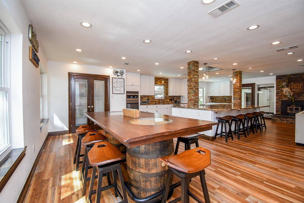 This dining space is ideal, perfectly positioned near the kitchen and living room. The walk-in pantry, with its stylish glass-front doors, adds a unique and charming touch to the room.