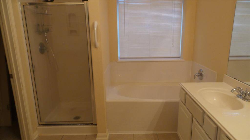 Master bath with separate shower and soaking tub