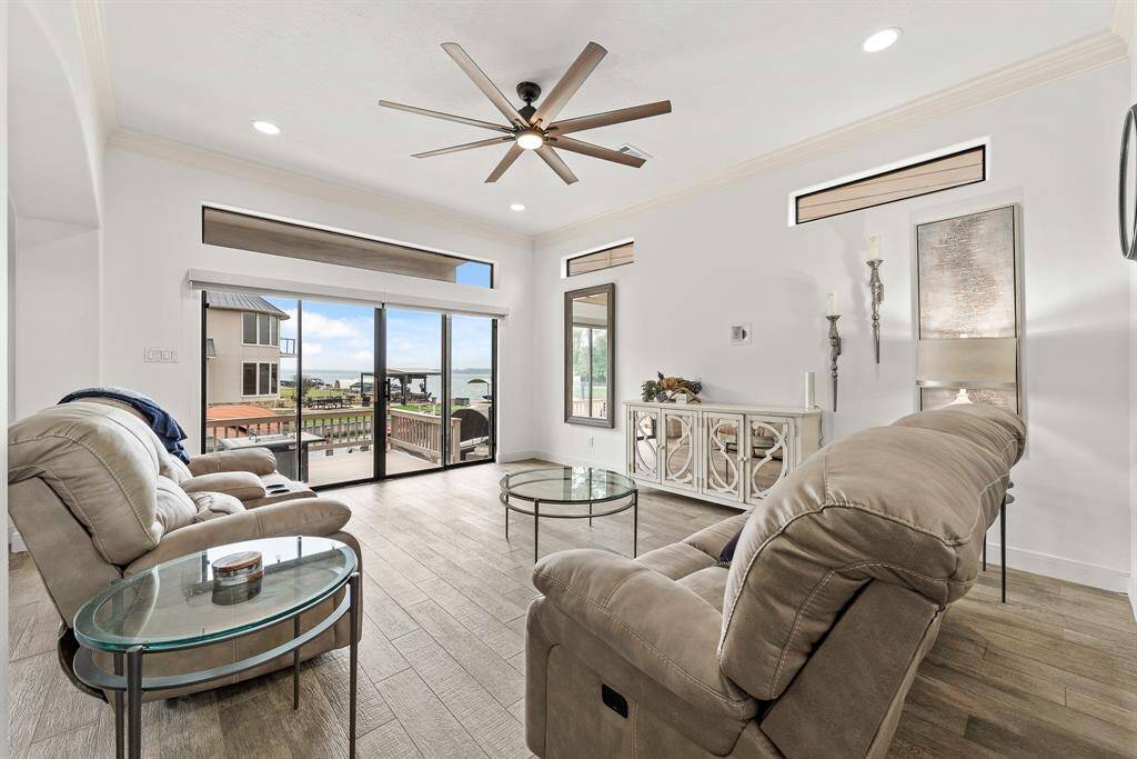 First floor living room with sliding door access to large waterfront deck