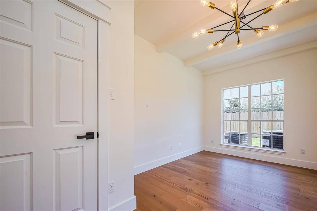 This could be a forth bedroom or a sunroom, a game room, or an office with custom beams overlooking the backyard.