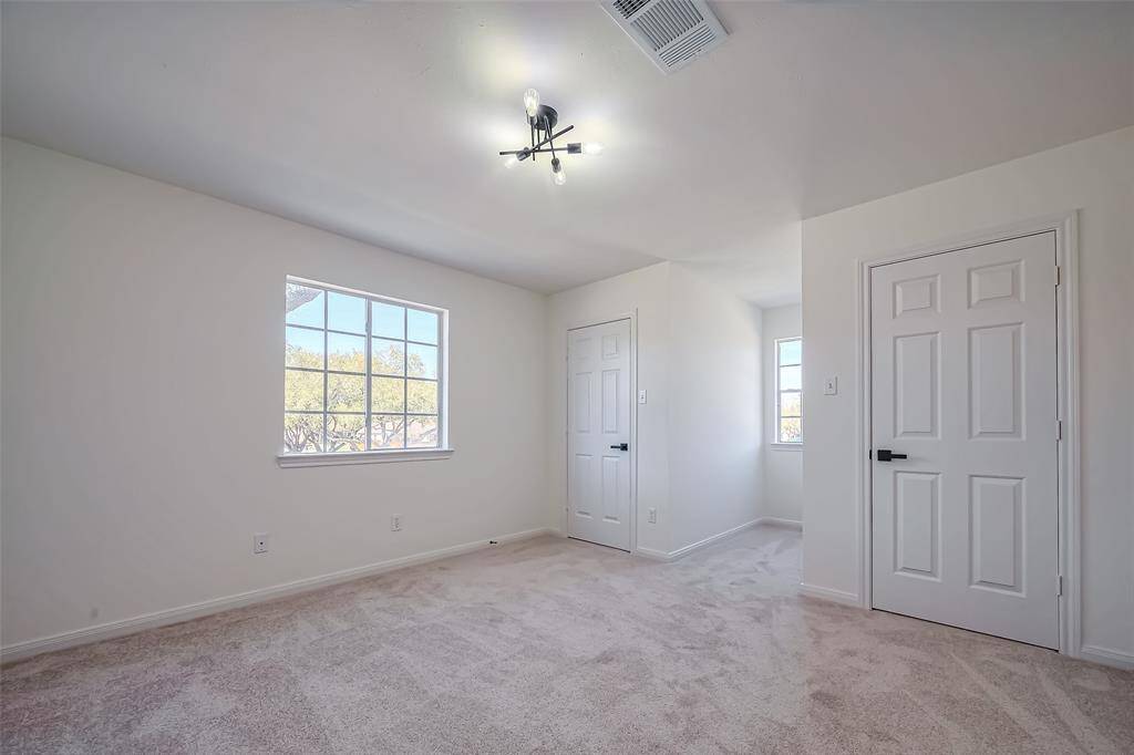 Additional bedroom upstairs with a featured wall.