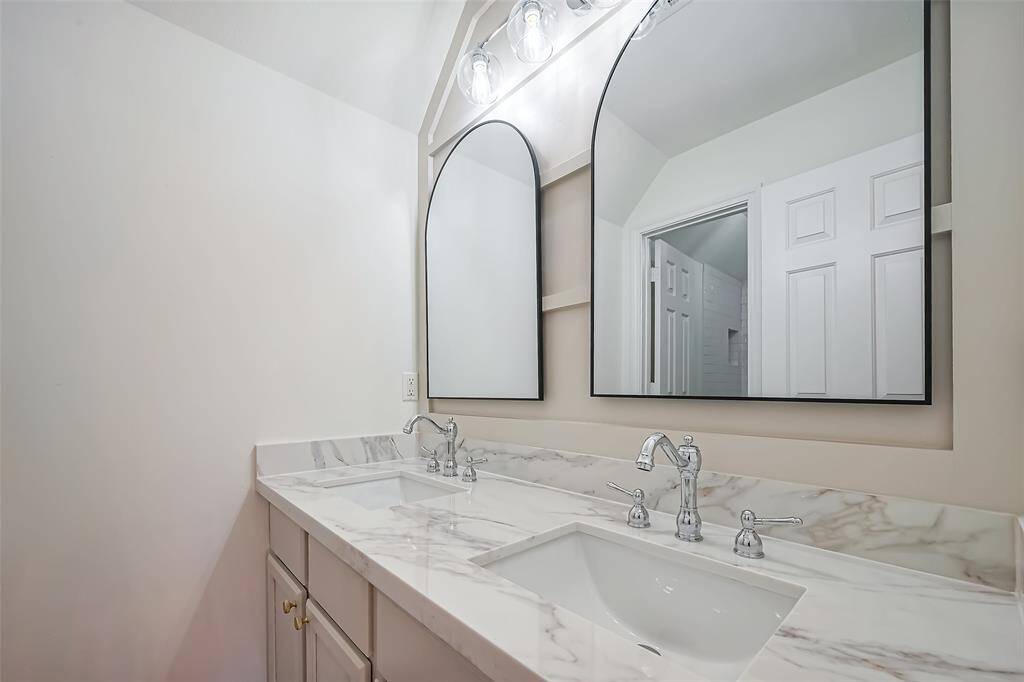 Upstairs bathroom with new counters, mirrors, hardware, and new floors.