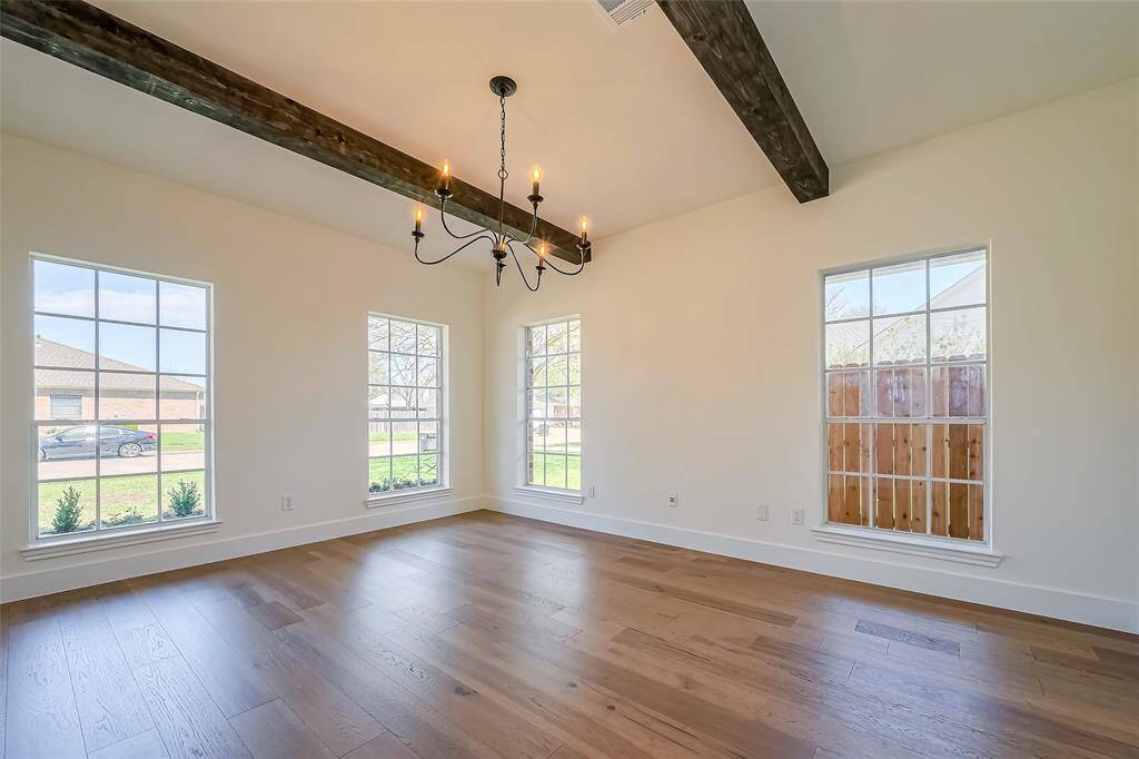 Experience luxury in this exquisite primary suite with an expansive bedroom space adorned with a chic new chandelier and custom wood beams. Pristine-engineered wood floors lead you to the indulgent, spa-inspired en suite bathroom.