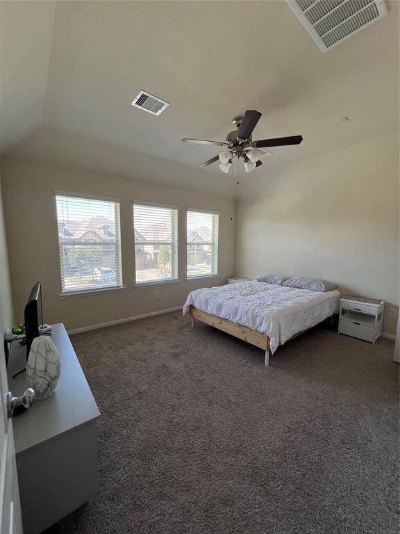 Primary bedroom has high ceilings and lots of space.