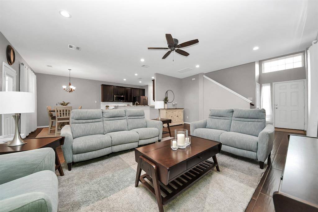 Gather the family and guests together in your lovely living room! Featuring high ceilings, recessed lighting, ceiling fan, custom paint, gorgeous tile floors, and large windows that provide plenty of natural lighting throughout the day.