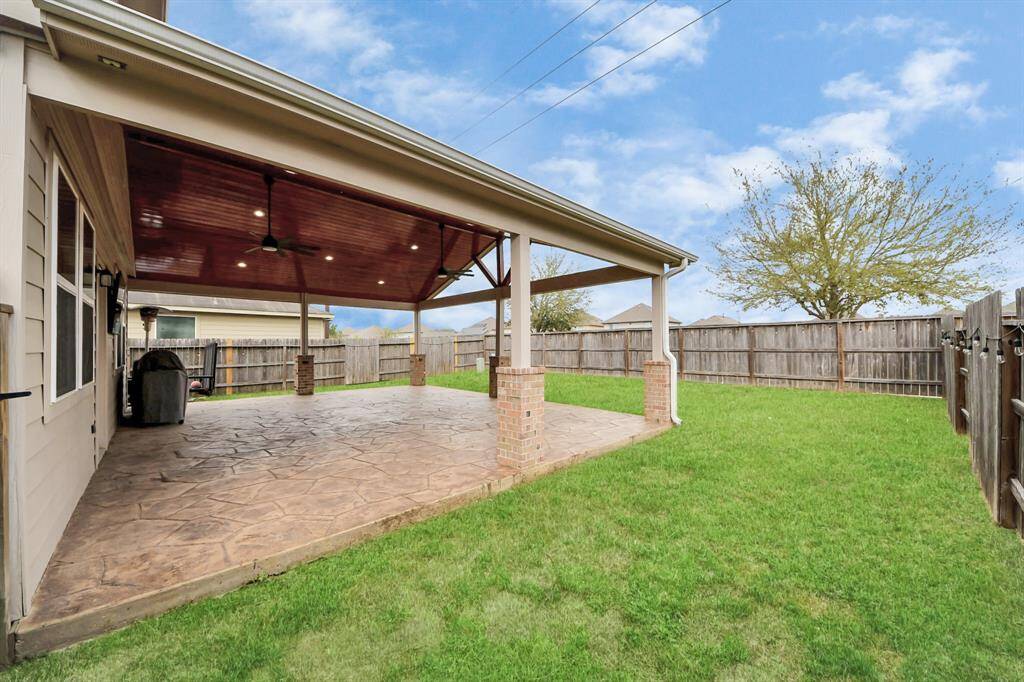 Recenlty built outdoor covered patio with stamped concrete. Enjoy family cookouts under this impressive patio.