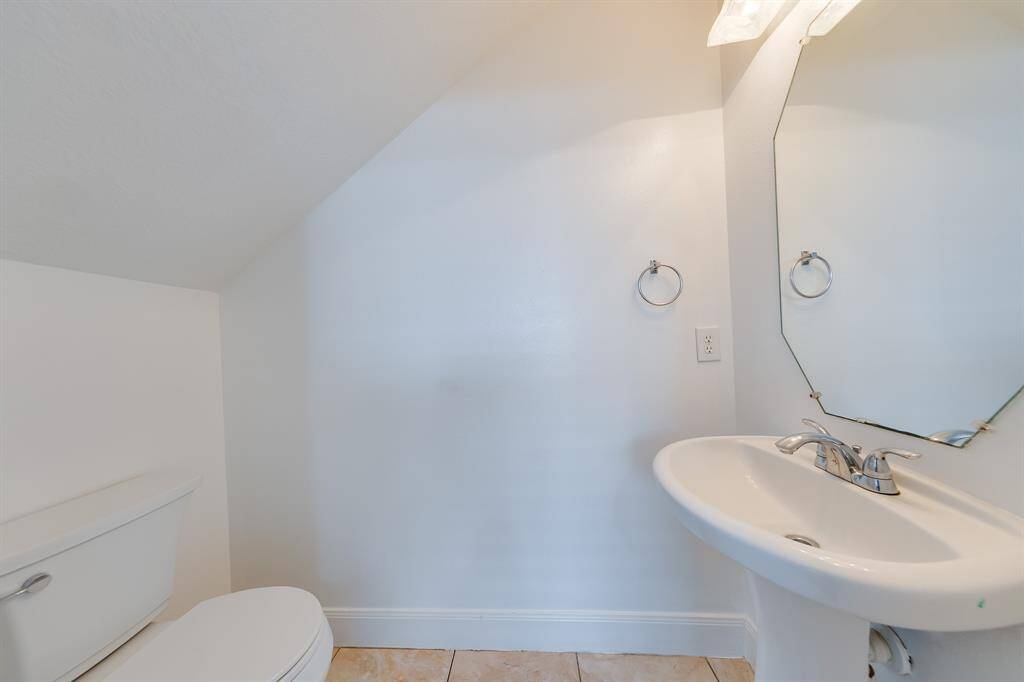 The half bath is a practical, clean space with a simple and functional design.