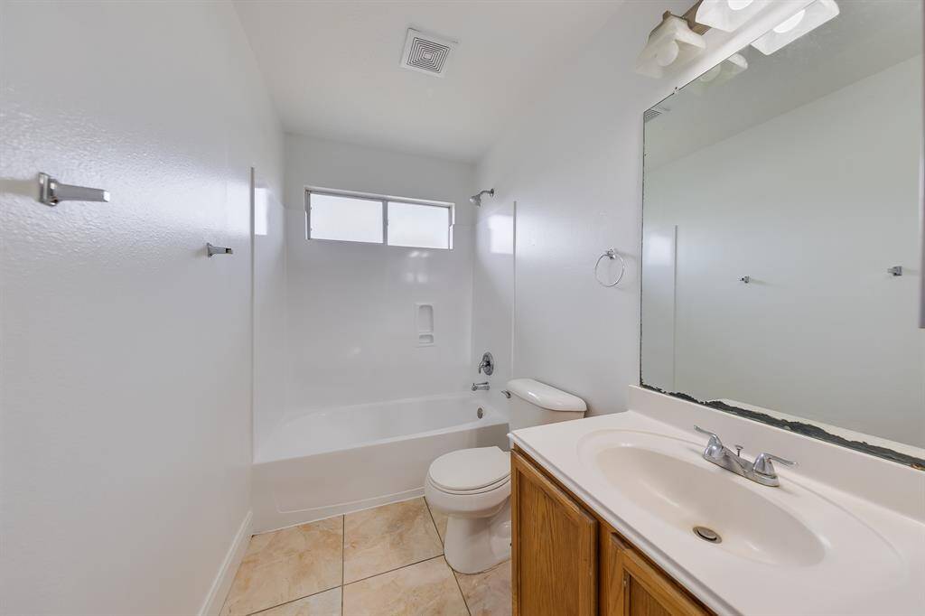 The upstairs secondary bathroom is practical and functional, offering convenience for busy mornings or relaxing evenings.