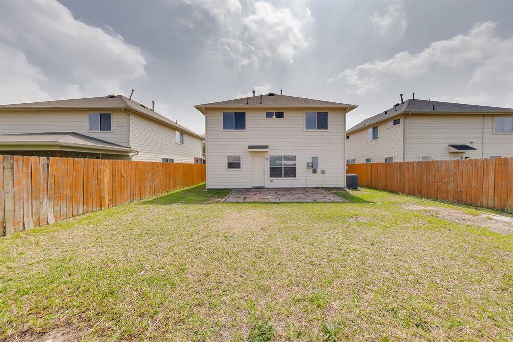 The backyard offers plenty of room, providing a great space for outdoor activities, gatherings, or simply enjoying the fresh air.