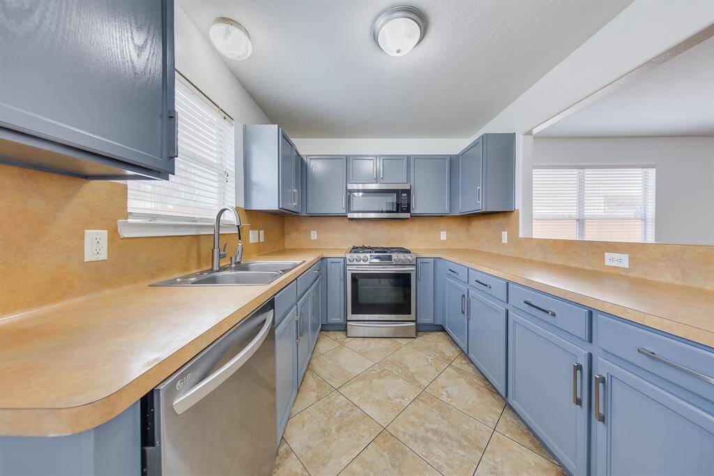 The front of the house is welcoming and well-kept, with a double-wide driveway that offers plenty of space for parking and easy access.
