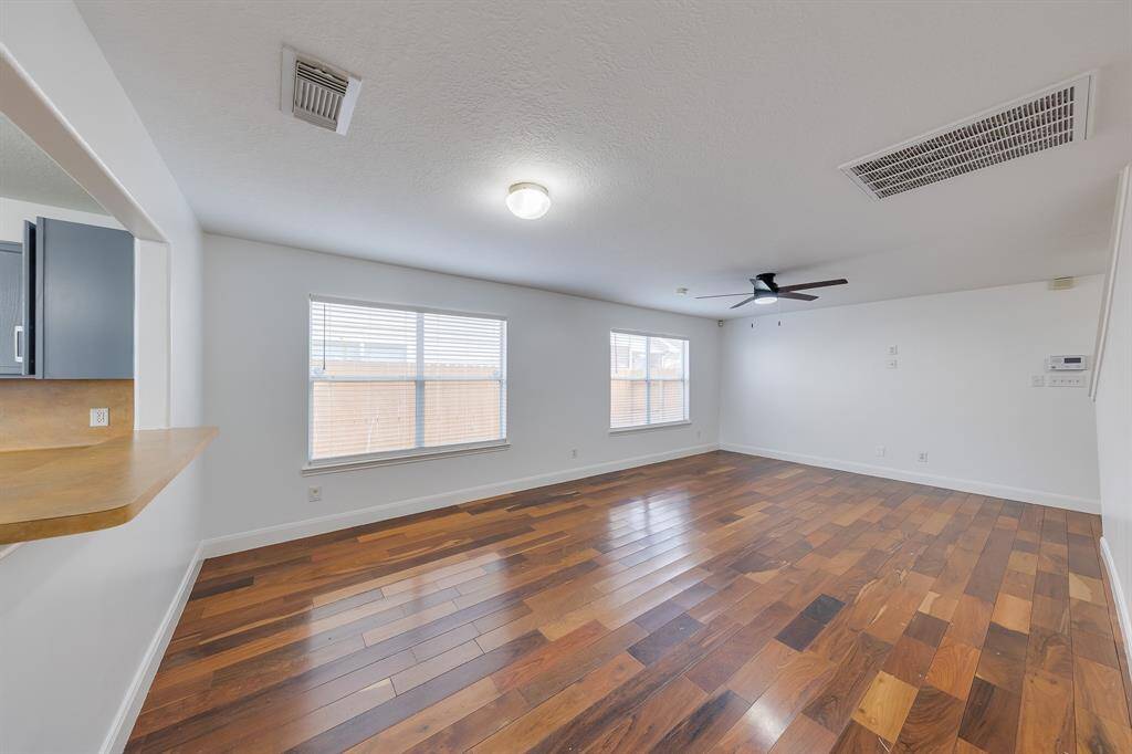 The living area is bright and inviting, with natural sunlight streaming through the windows, perfect for relaxing.