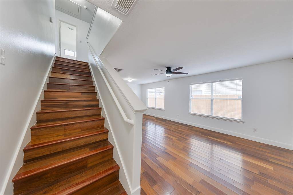Step inside to a bright, welcoming space with a cozy living area and staircase leading to the rest of the home.