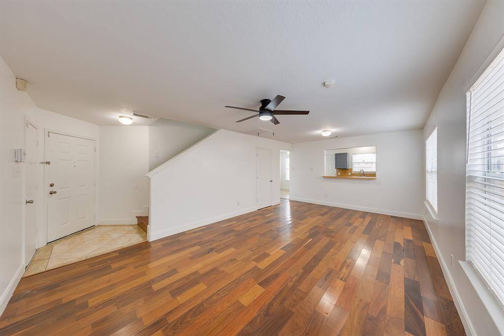 The living area seamlessly flows into the kitchen, creating an open space ideal for daily living and entertaining.