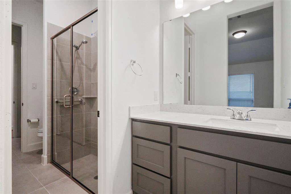 This guest bath is the Jack & Jill bath. There is a sink on either side of the shower for each bedroom.