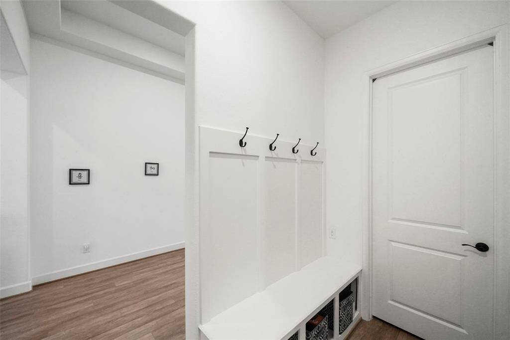 This mud room is just off the 3 car garage as you enter the home. The door leads to the laundry room.