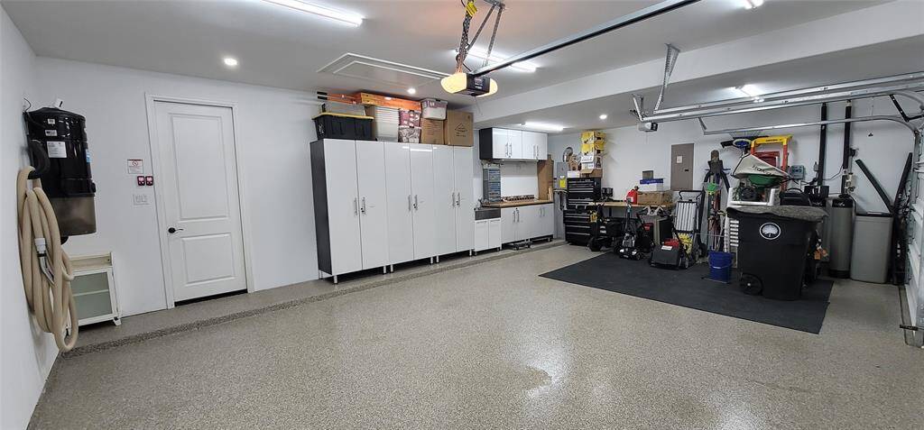 Look how clean this 3 car garage is! Polyaspartic Floor coating in the garage was a $4000 upgrade.This home also has central vacuum, and a water softener.