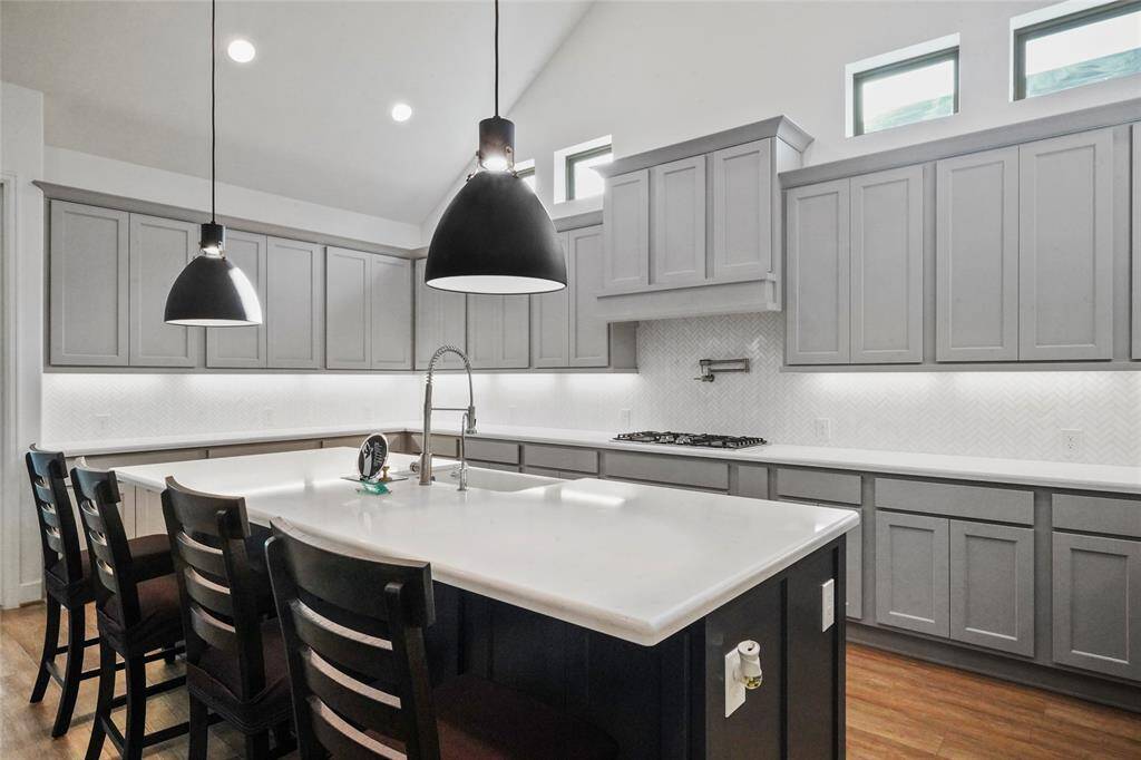 The owners also added a pot filler to the kitchen when they built the home. Amazing Quartz counter tops with a beautiful white backsplash and a farmhouse sink.