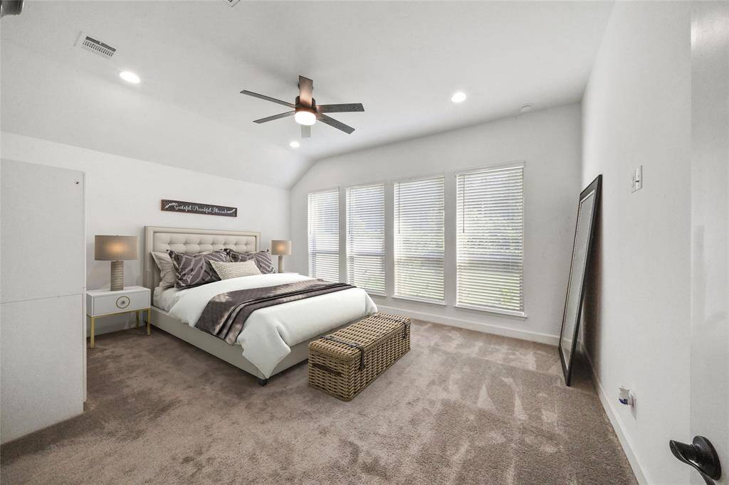 Spacious Primary bedroom with views of the nature preserve. The owners upgraded the fans in this room and the living room. "Virtually staged"