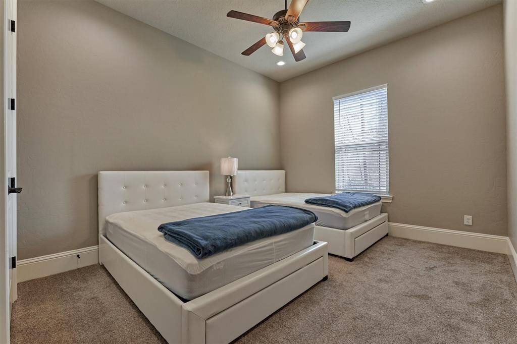 The third guest bedroom upstairs is spacious enough to accommodate two full-size beds and also includes an en-suite bath and a walk-in closet for added convenience and comfort.