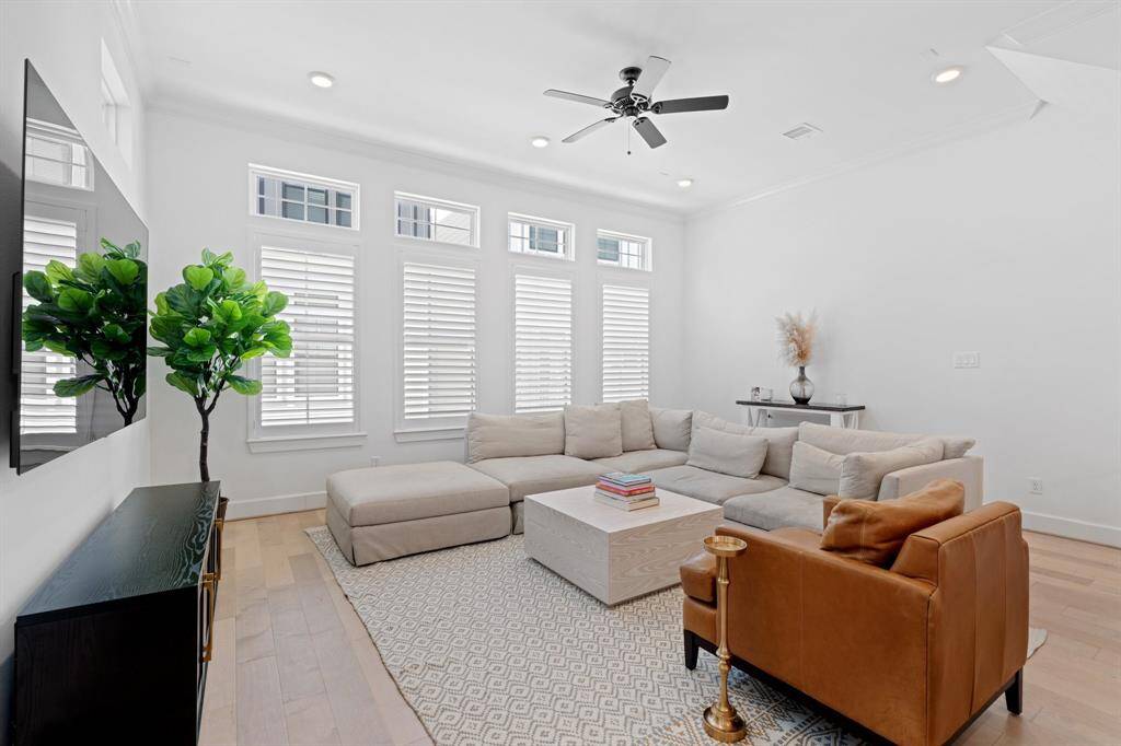 With soaring high ceilings, plantation shutters throughout the home, and light wood floors, the space offers a perfect blend of timeless elegance and cozy comfort.