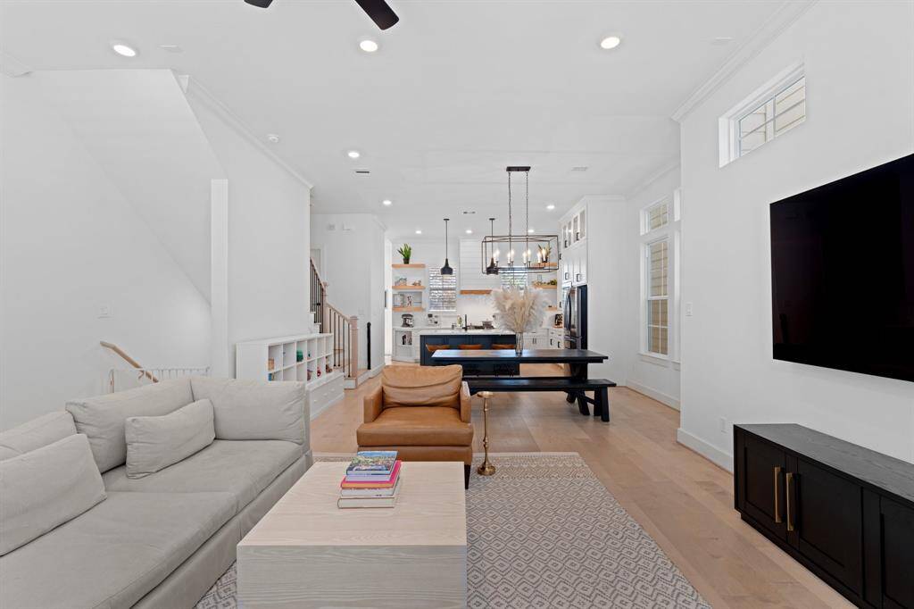 View of the living space opening up into the dining area and kitchen beyond.