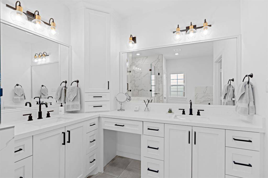 Ample cabinet space is complemented by a stylish vanity, offering both storage and functionality.